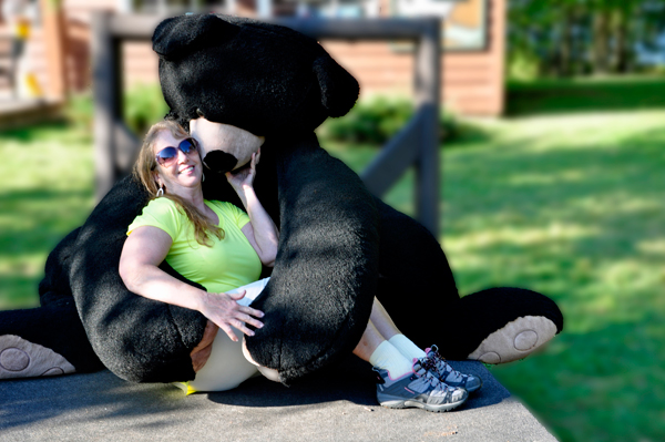 Karen Duquette getting a kiss and hug from a bear